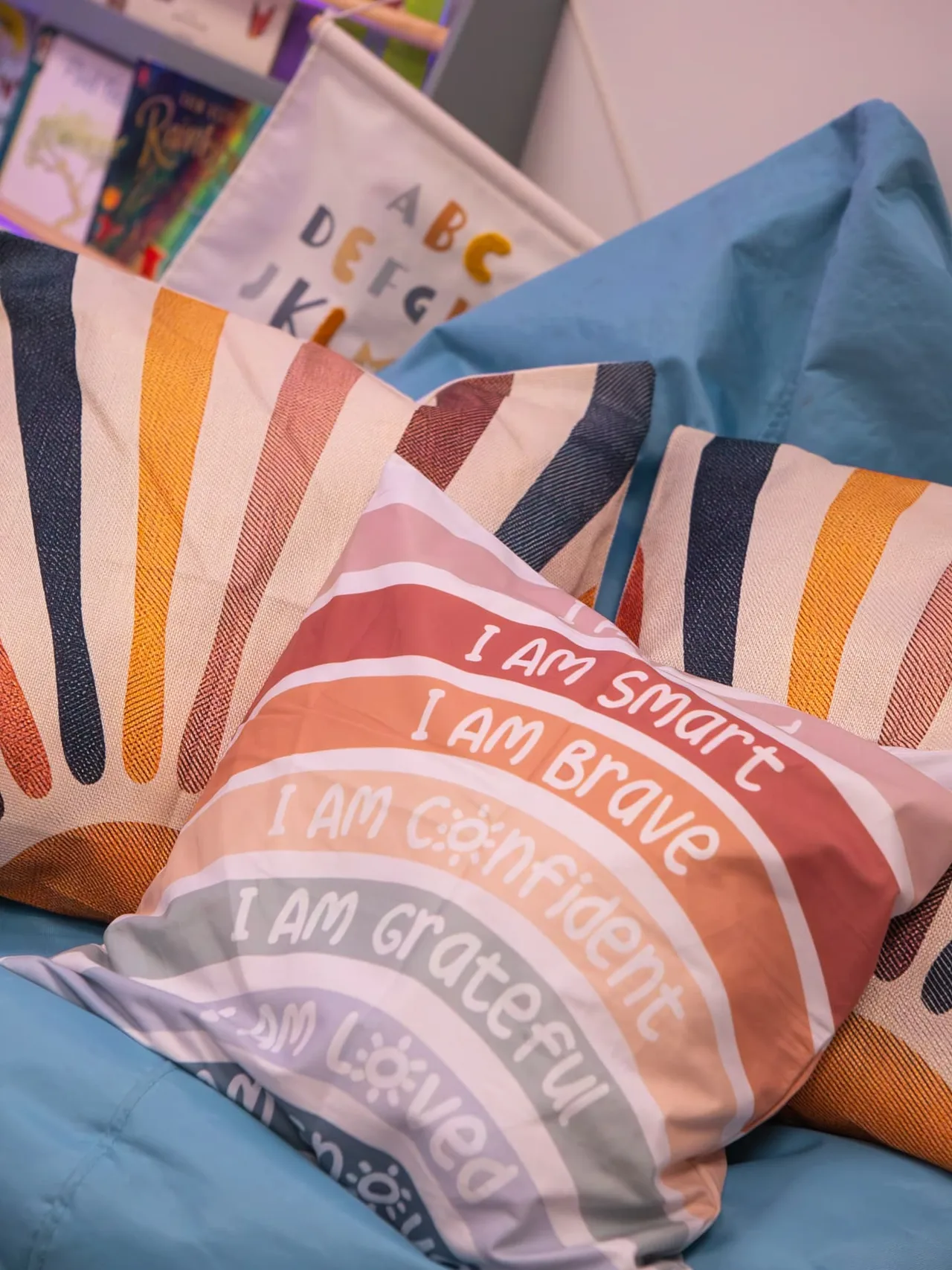 A rainbow 'be kind' cushion on the window bench in the Connect waiting area