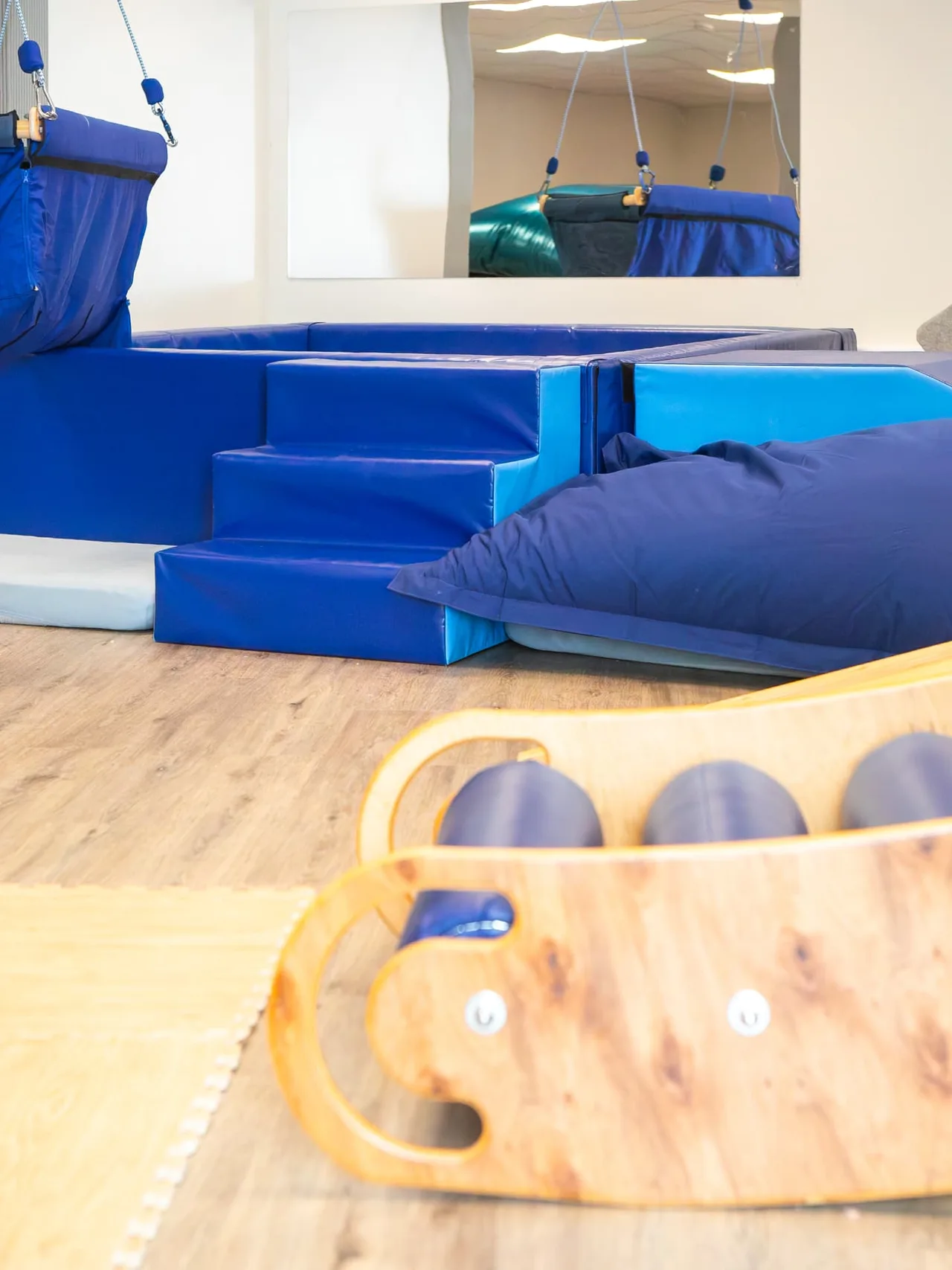 Soft play steps, crash mats and a therapy swing in the Connect soft play room